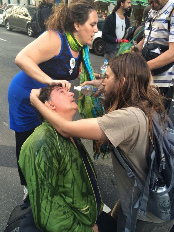 Photo by Ruddy Turnstone at Flood Wall Street, 21 September 2014 as the people wash pepper spray out of their  eyes.